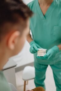 Licensed editorial dental consultation showing real clinician and patient